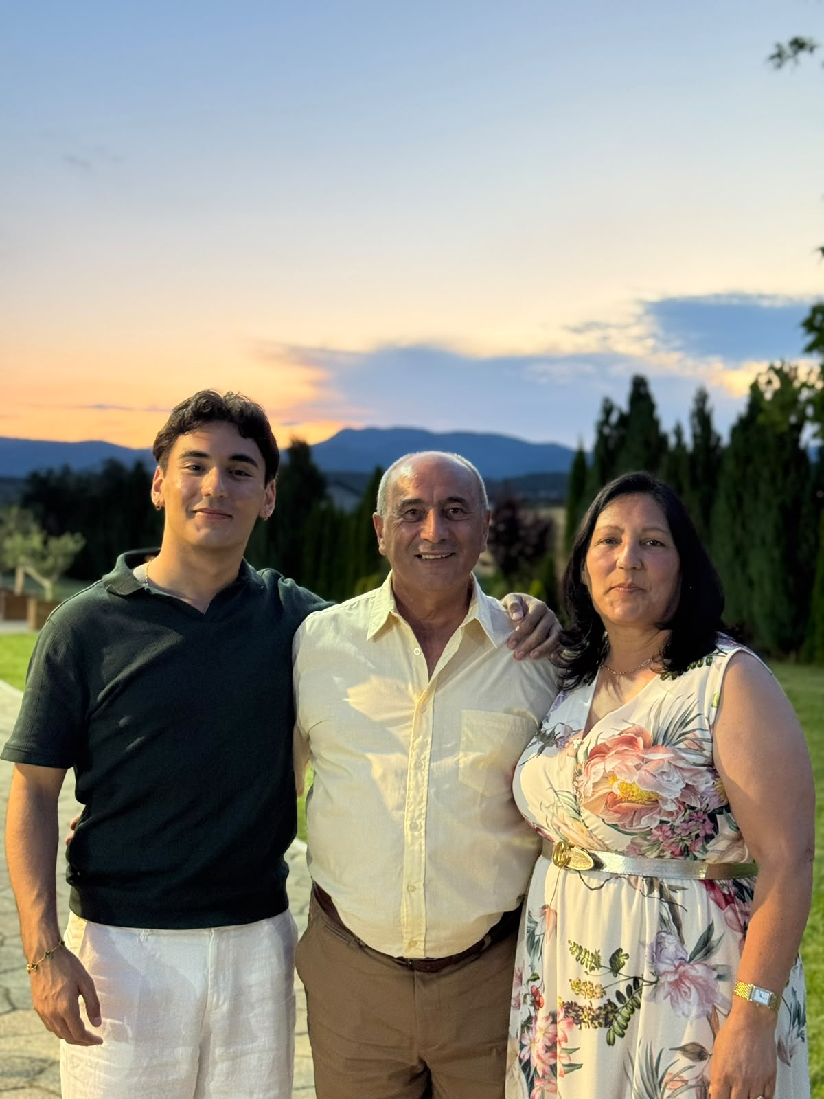 Raymond with Clayton and Sandra outdoors at sunset