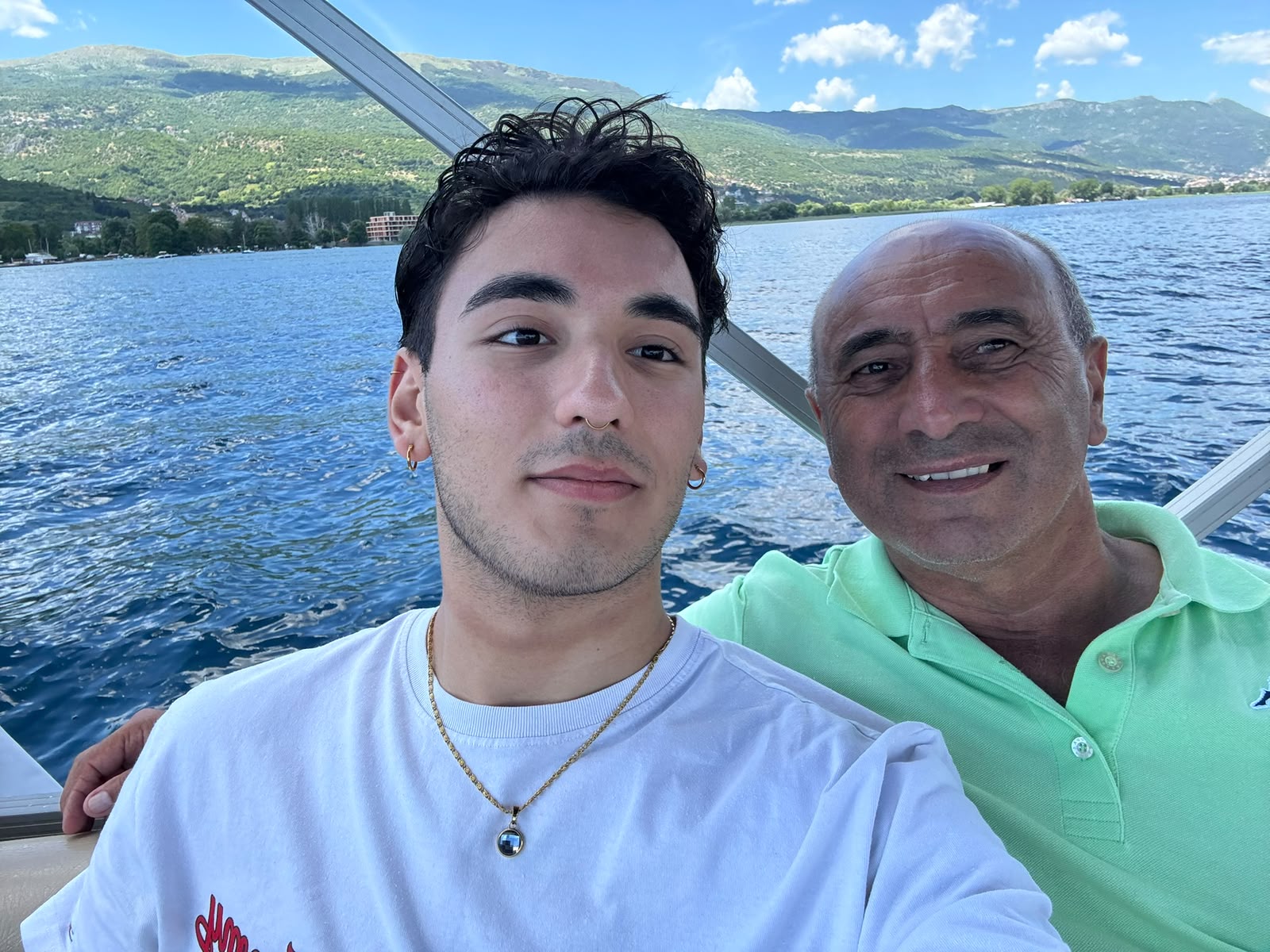 Raymond and Clayton on a boat by the mountains